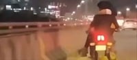 Traffic Violation: The man was driving the bike with the woman sitting on his lap